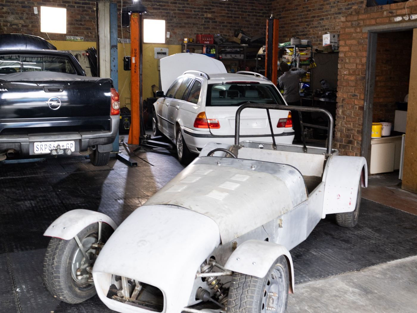 A bare-metal kit car build standing in the CRS Auto workshop