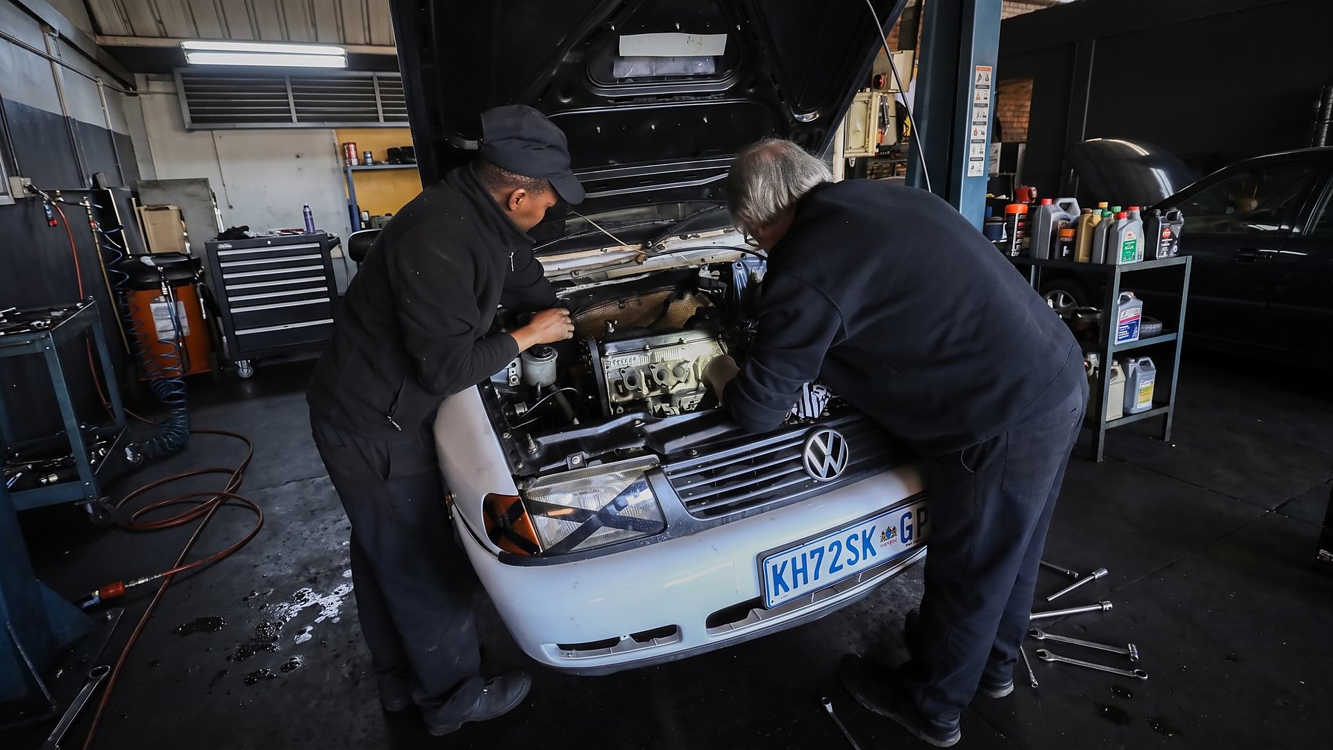 Shaun and the CRS Auto team working under the bonnet of a customer's car in the Fairland workshop