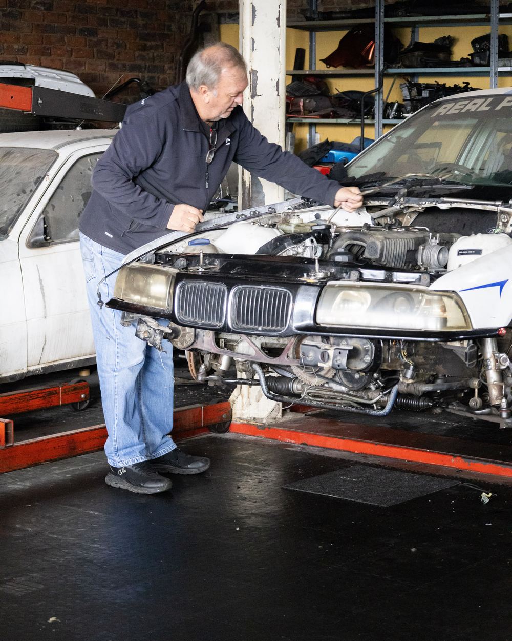 Shaun Dodd working on a car on the lift at CRS Auto