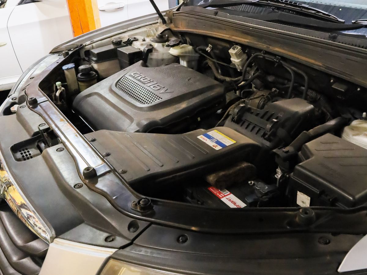 An engine bay open for inspection at CRS Auto