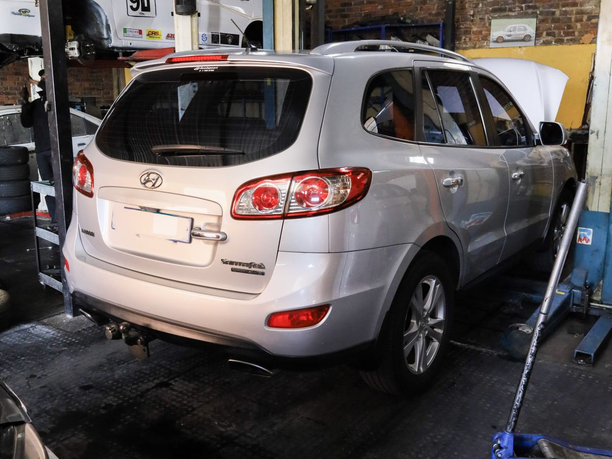 A used SUV up on the lift for a pre-purchase inspection at CRS Auto