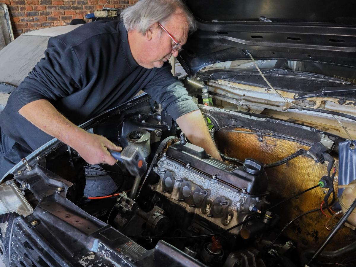 Shaun working deep in an engine bay at CRS Auto